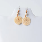 Cream-colored engraved tagua earrings with honeycomb texture, beads, and braided cord accents from lana eco-chic
