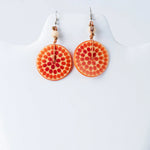 Lana eco-chic engraved tagua earrings in orange with red dot pattern and metallic hooks featuring small beads
