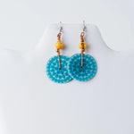 Turquoise circular engraved tagua earrings with dotted pattern small yellow beads and copper wire accents