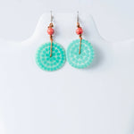 Turquoise circular engraved tagua earrings with dotted pattern, coral beads, and gold-toned hardware by lana eco-chic