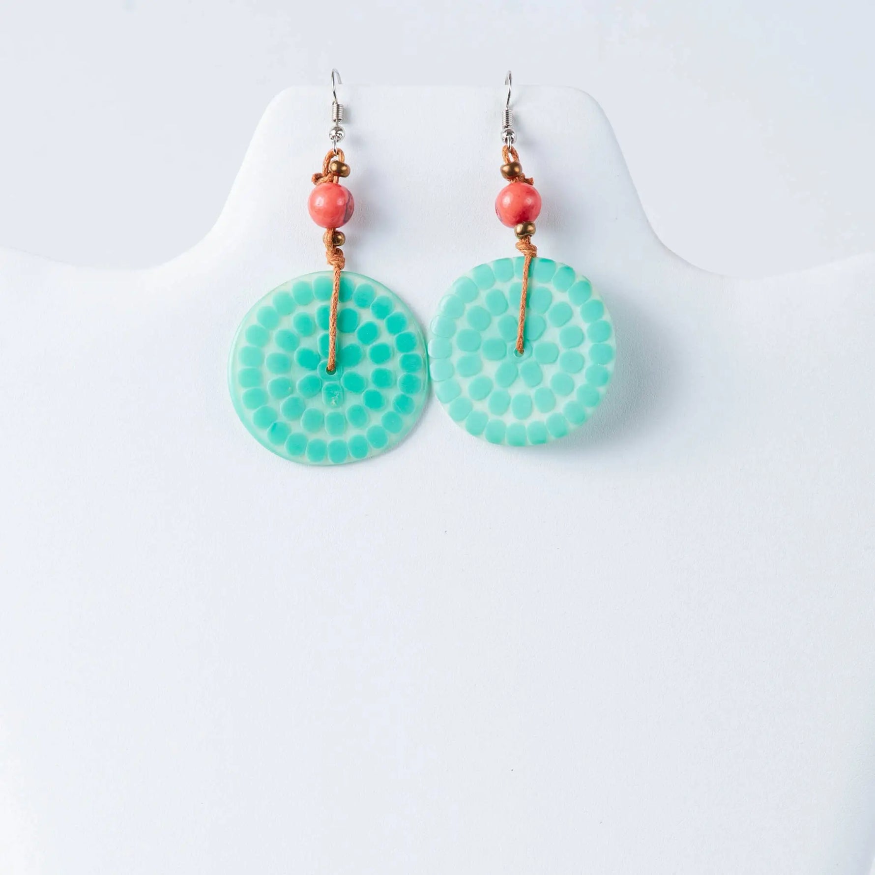 Turquoise circular engraved tagua earrings with dotted pattern, coral beads, and gold-toned hardware by lana eco-chic