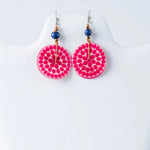 Vibrant pink lana eco-chic engraved tagua earrings with glossy finish, dotted pattern, and navy blue bead accents