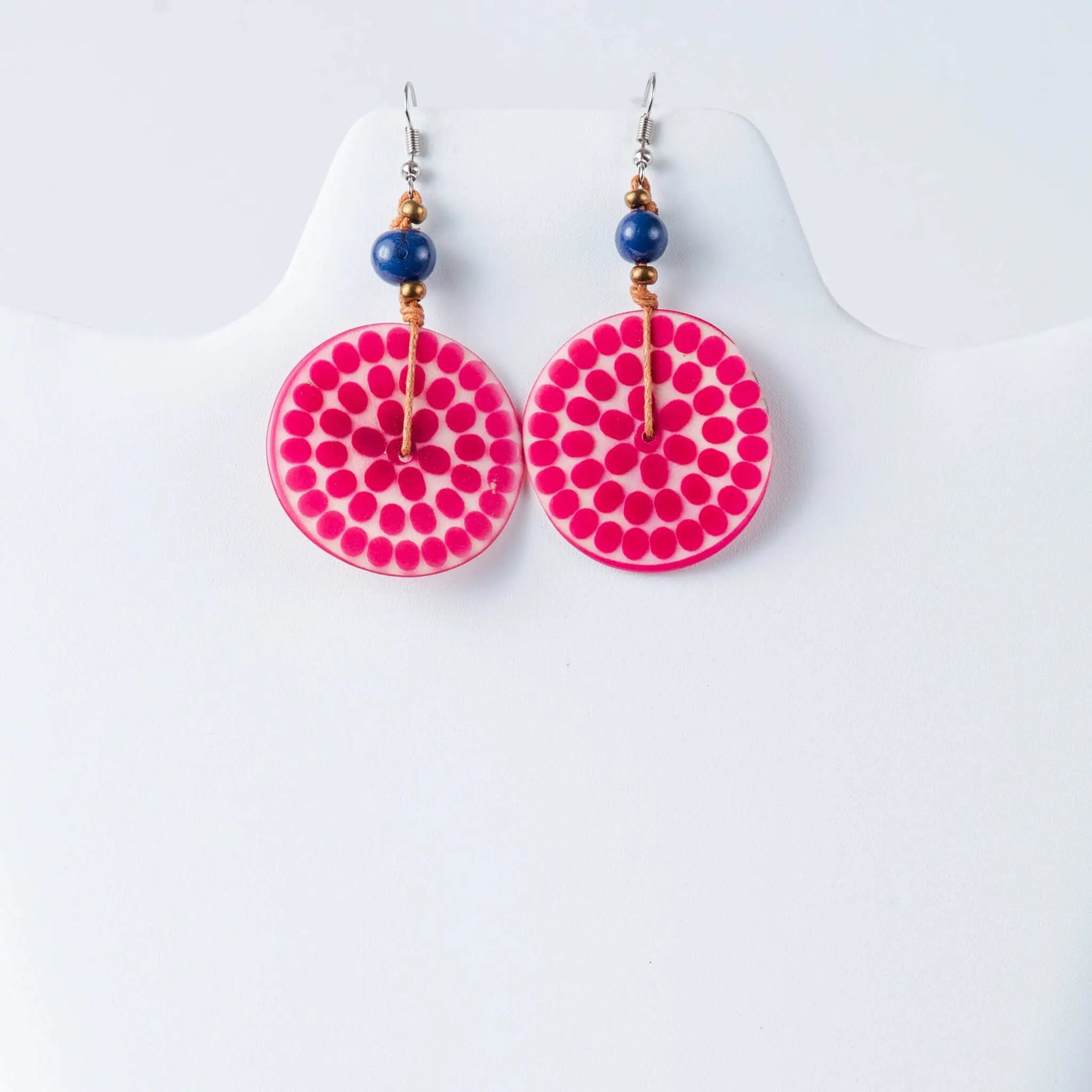 Vibrant pink lana eco-chic engraved tagua earrings with glossy finish, dotted pattern, and navy blue bead accents