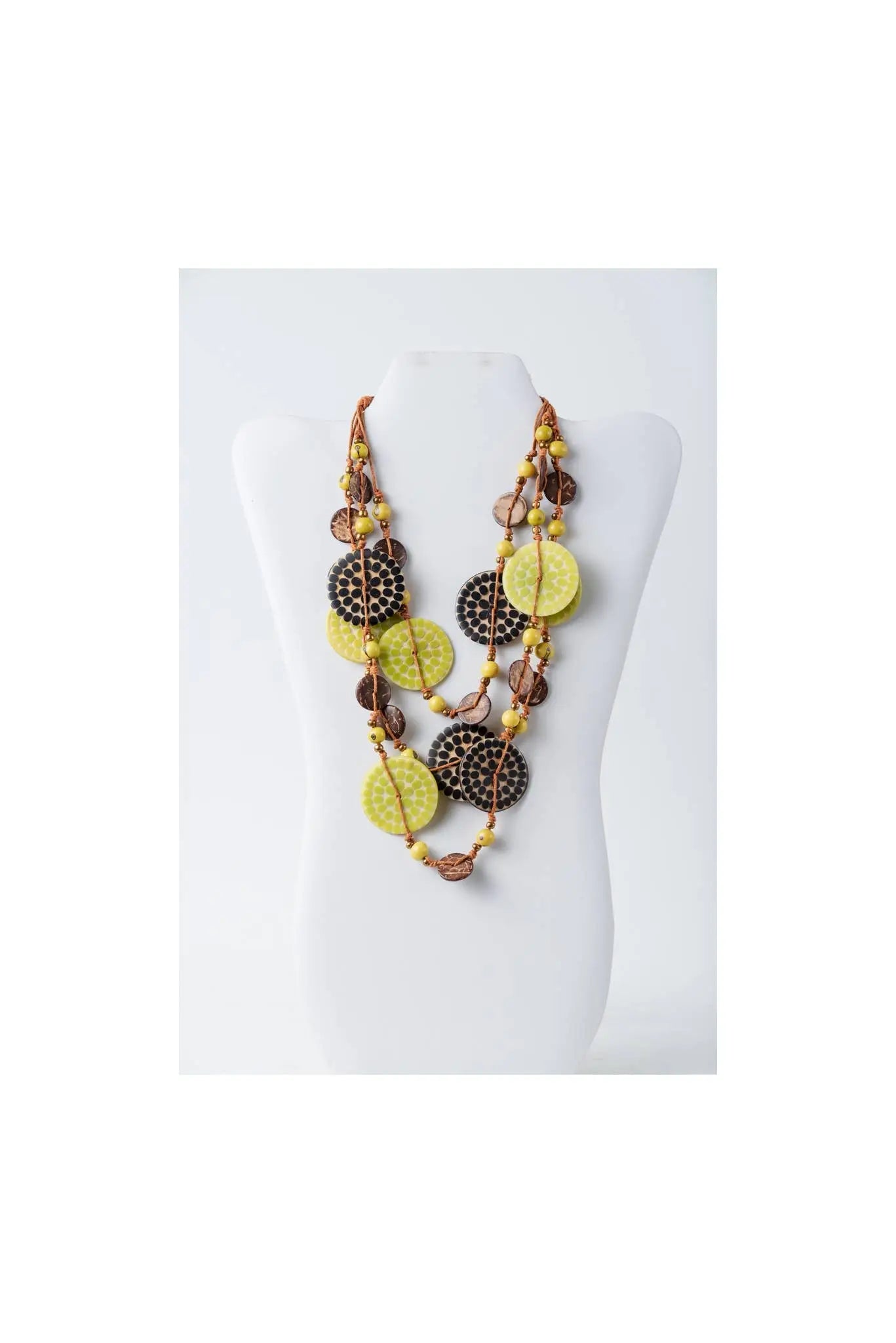 A layered necklace with vibrant lime green and dark brown engraved tagua beads on a natural coconut cord