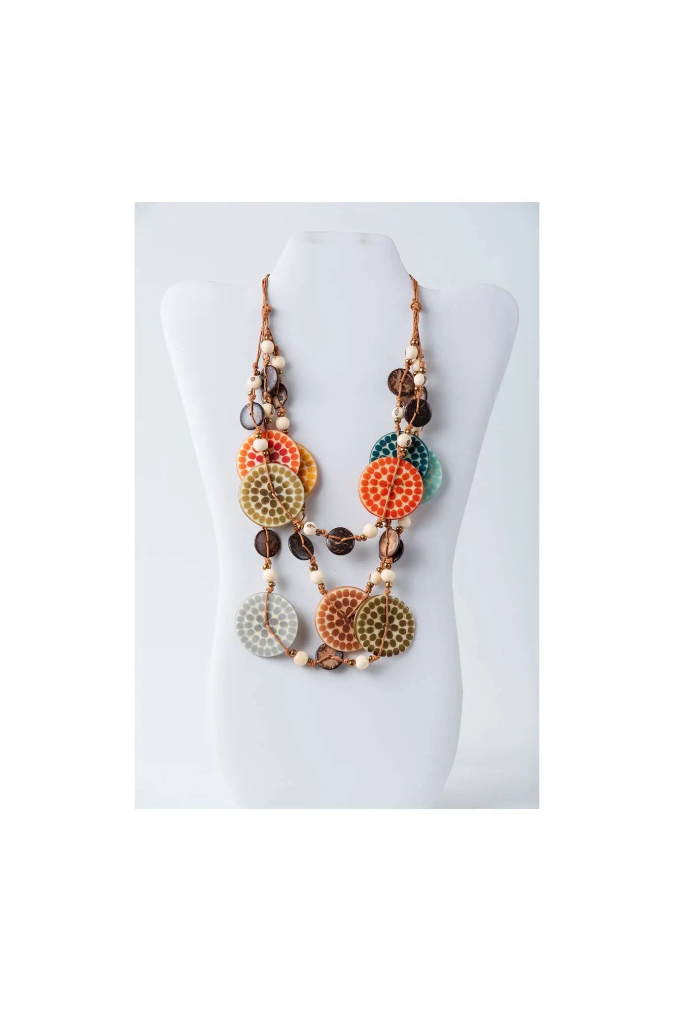 A vibrant layered necklace with engraved tagua beads and wooden metallic accents in orange green and brown tones