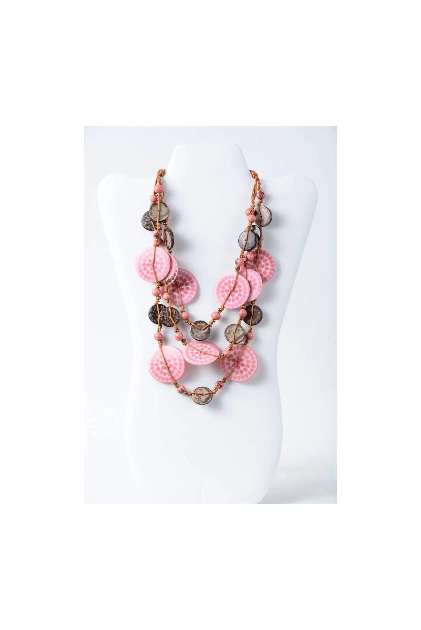 Layered necklace with engraved tagua beads in pink and brown featuring a hammered finish for eco chic style