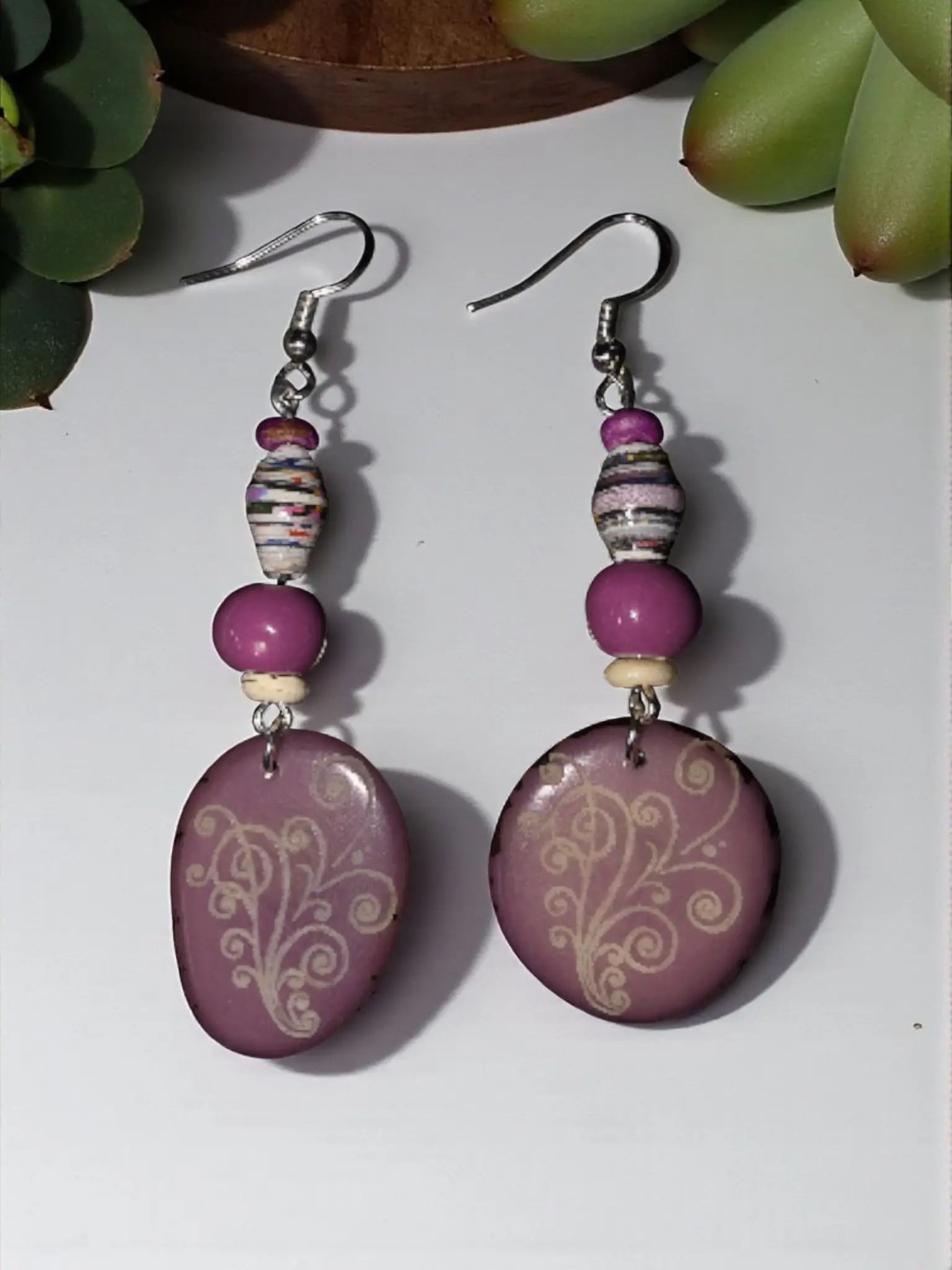 Lavender swirl engraved tagua earrings with purple oval paper wrapped beads and delicate white swirl patterns