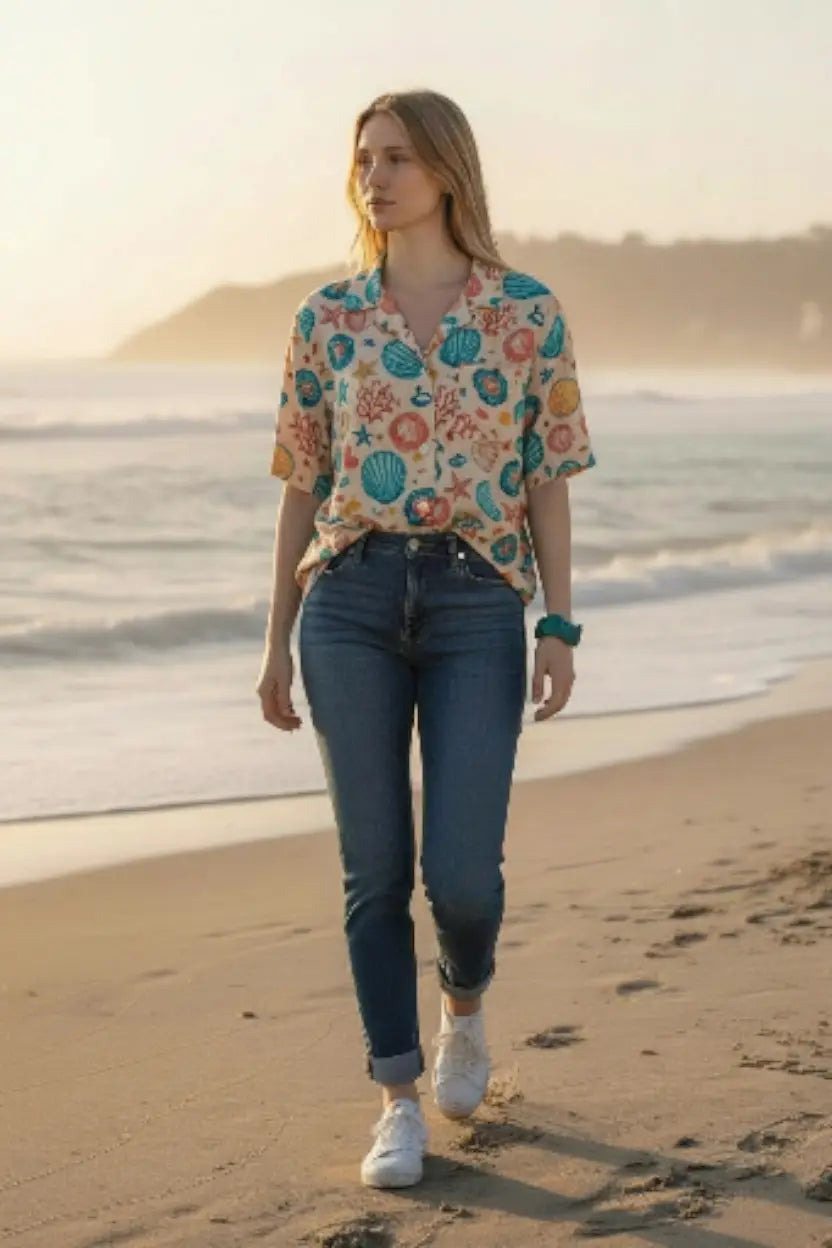 A woman wearing a sea-themed shirt with a limeade summer green carved tagua nut vegetable ivory forest seed bracelet