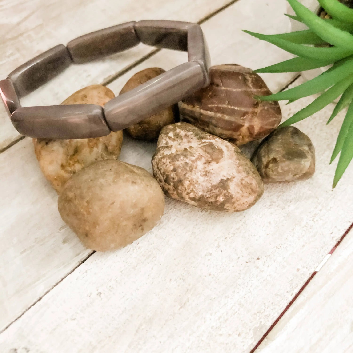 Loja bracelet gray is a sleek matte brown stone bracelet with a flexible segmented design