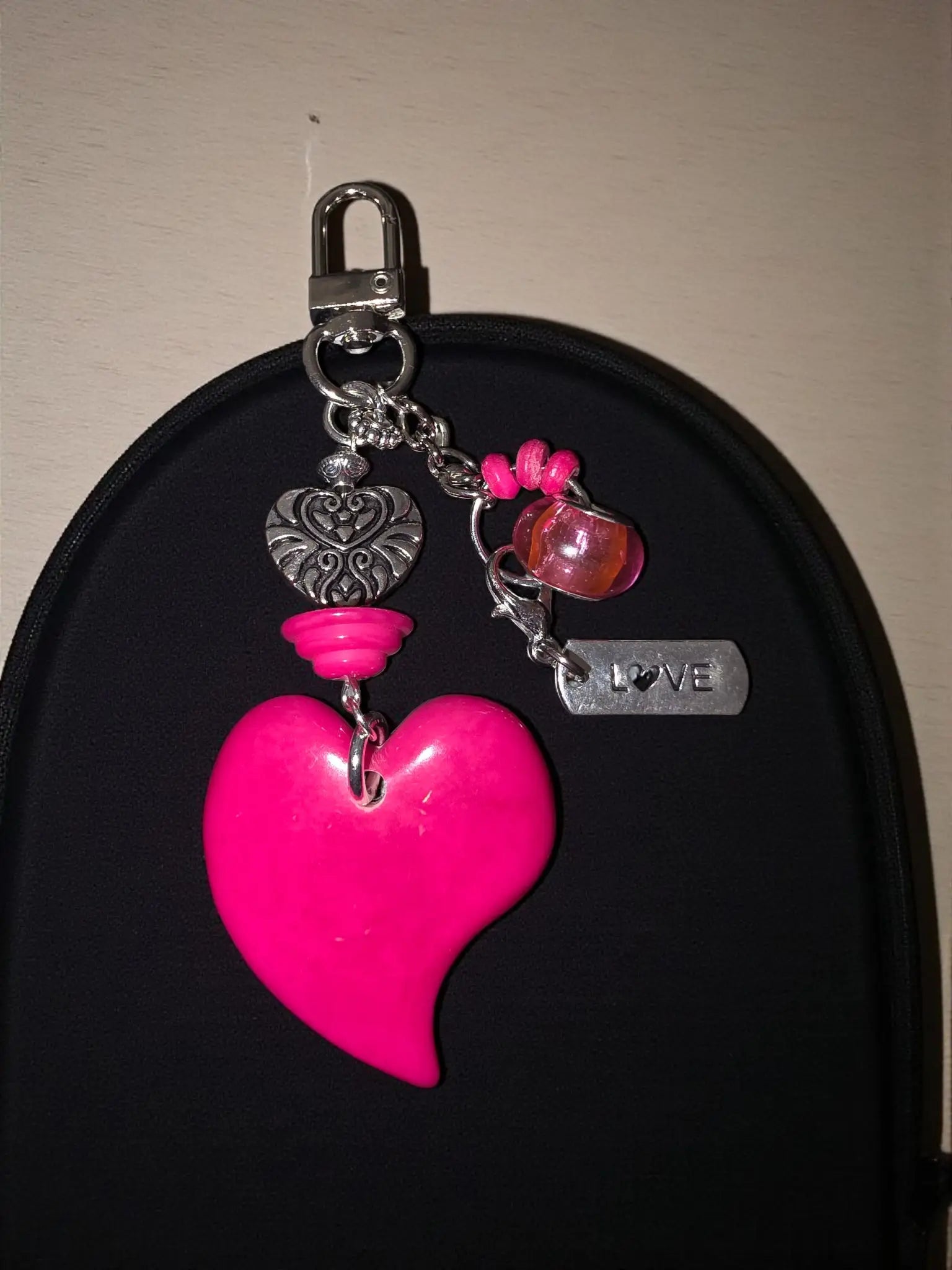 Bright pink heart tagua carved bag charm keychain with silver metal accents and a dangling love tag handmade