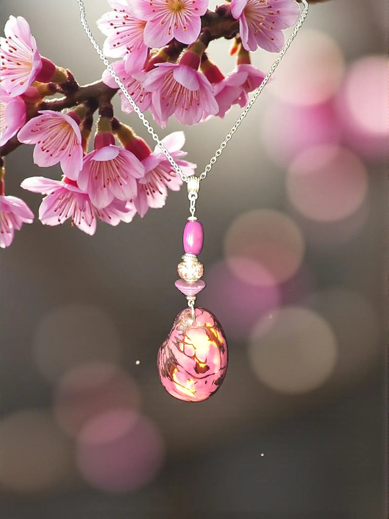 A delicate silver chain necklace with a vibrant pink marbled glass pendant and gold accents called luscious lavender tagua slice pendant necklace