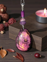 A luscious lavender natural marble tagua slice pendant necklace with a glossy pink and gold marbled egg-shaped pendant