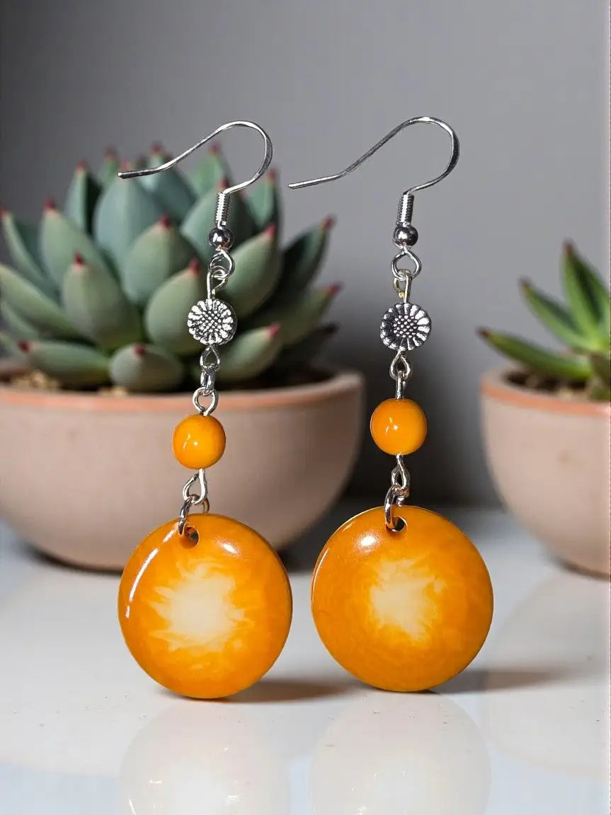 Orange circular pendant earrings with sunburst pattern silver-toned hooks vegetable ivory eco-friendly handmade usa