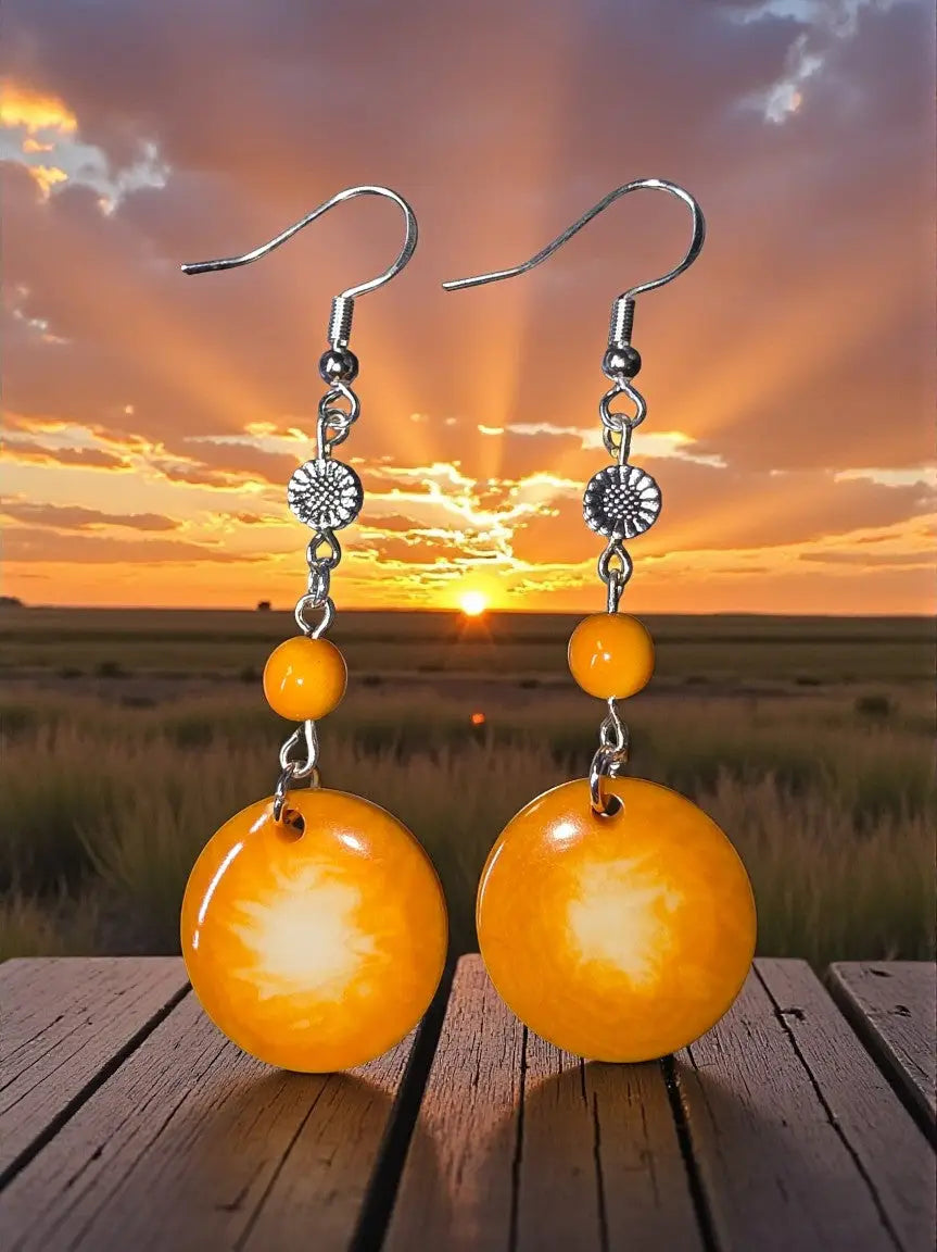 Orange circular vegetable ivory pendant earrings with silver hooks and sunburst charms from misty collection usa