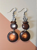 Brown wooden disc dangle earrings with silver flower charms and hooks from turquoise misty eco-friendly collection