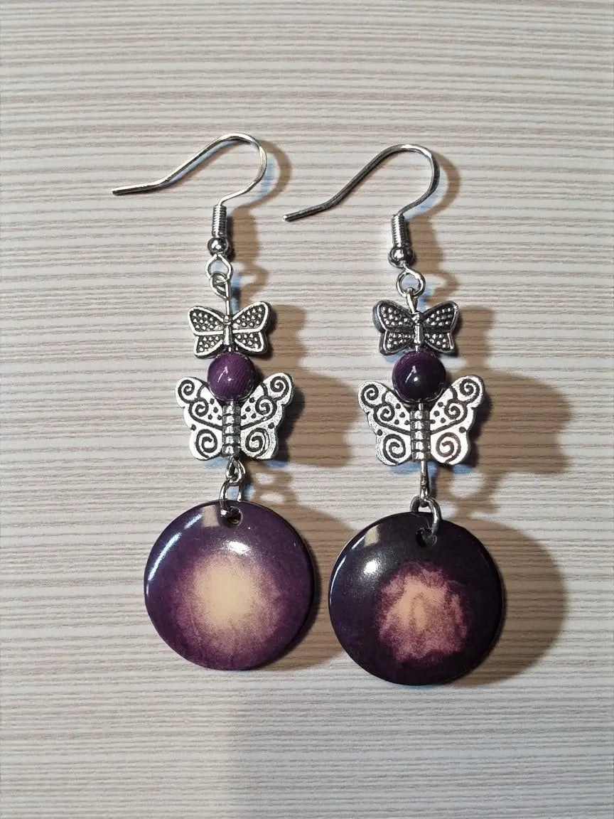 Purple gradient disc vegetable ivory eco-friendly earrings with silver butterfly charms and central purple bead from misty collection
