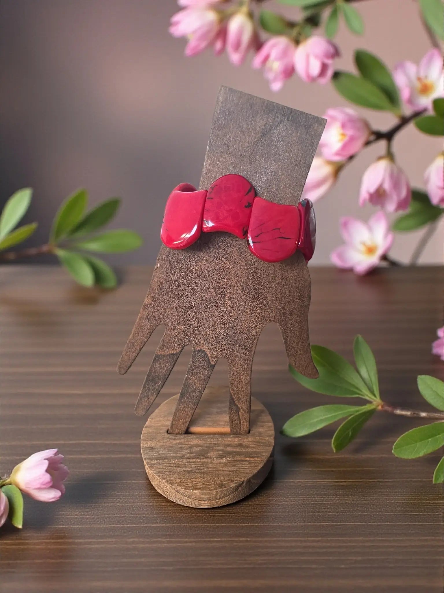 A vibrant red glossy marble ruby red carved tagua nut bracelet resembling forest seed bracelets design
