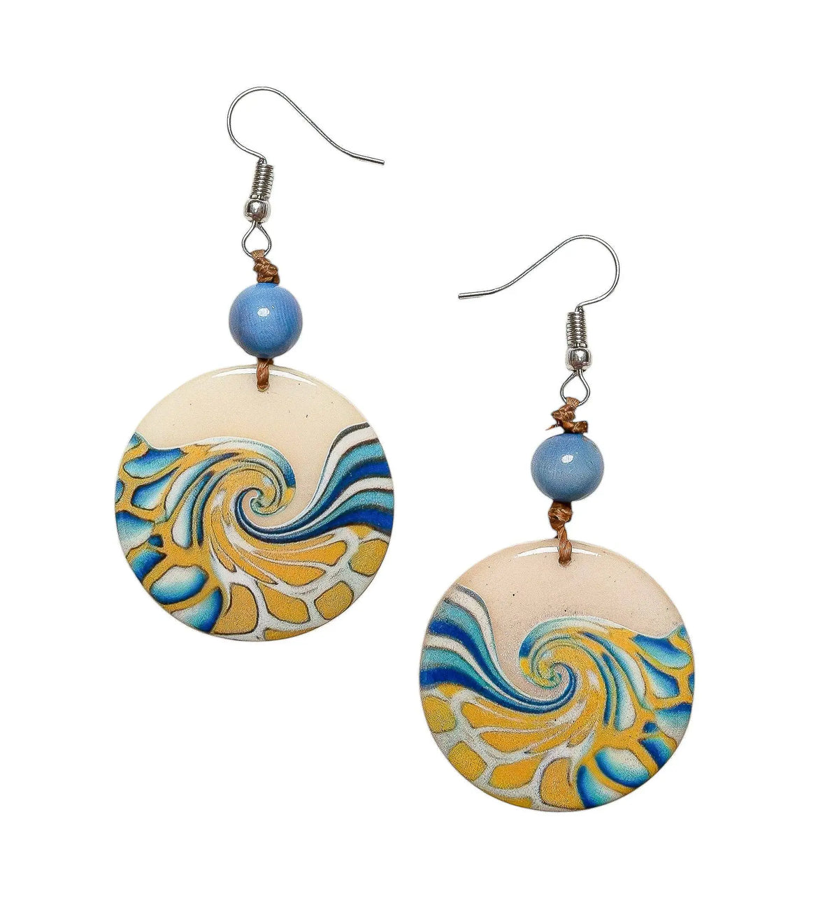 Mauren earrings feature blue and yellow swirl tagua nut circles with a beige base silver hooks and small blue beads