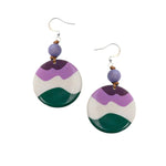 Mauren earrings with purple white and green layered tagua nut circles and a small purple bead above each hook