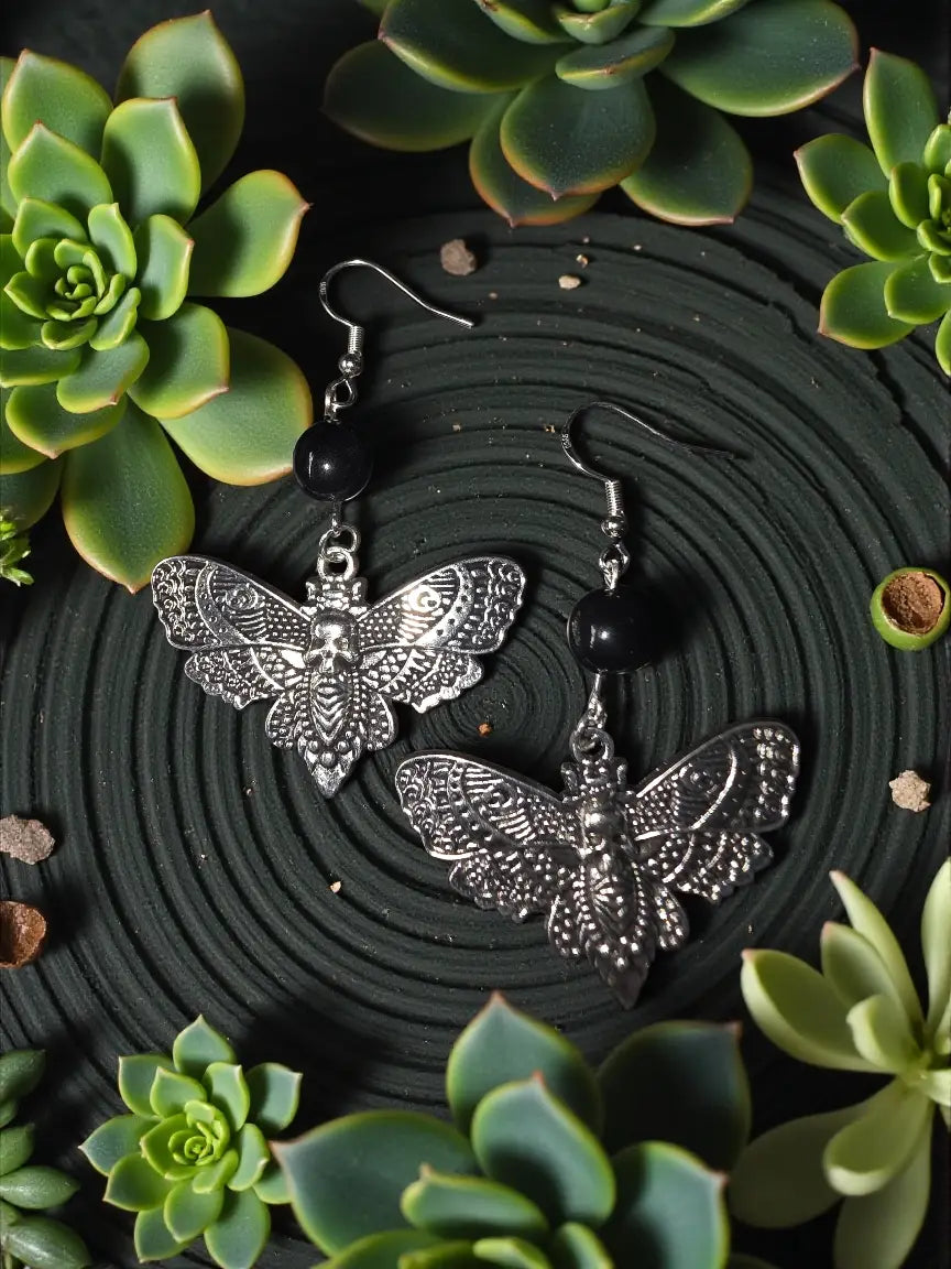 Silver moth earrings with intricate detailing and black tagua nut beads featuring detailed cicada and moth design