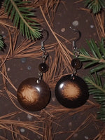 Dark brown circular misty chocolate tagua carved nut earrings with swirling marbled pattern and small dark beads from ecuador