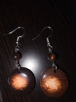 Brown circular misty chocolate tagua carved nut earrings with marbled pattern and small beads from ecuador rainforest
