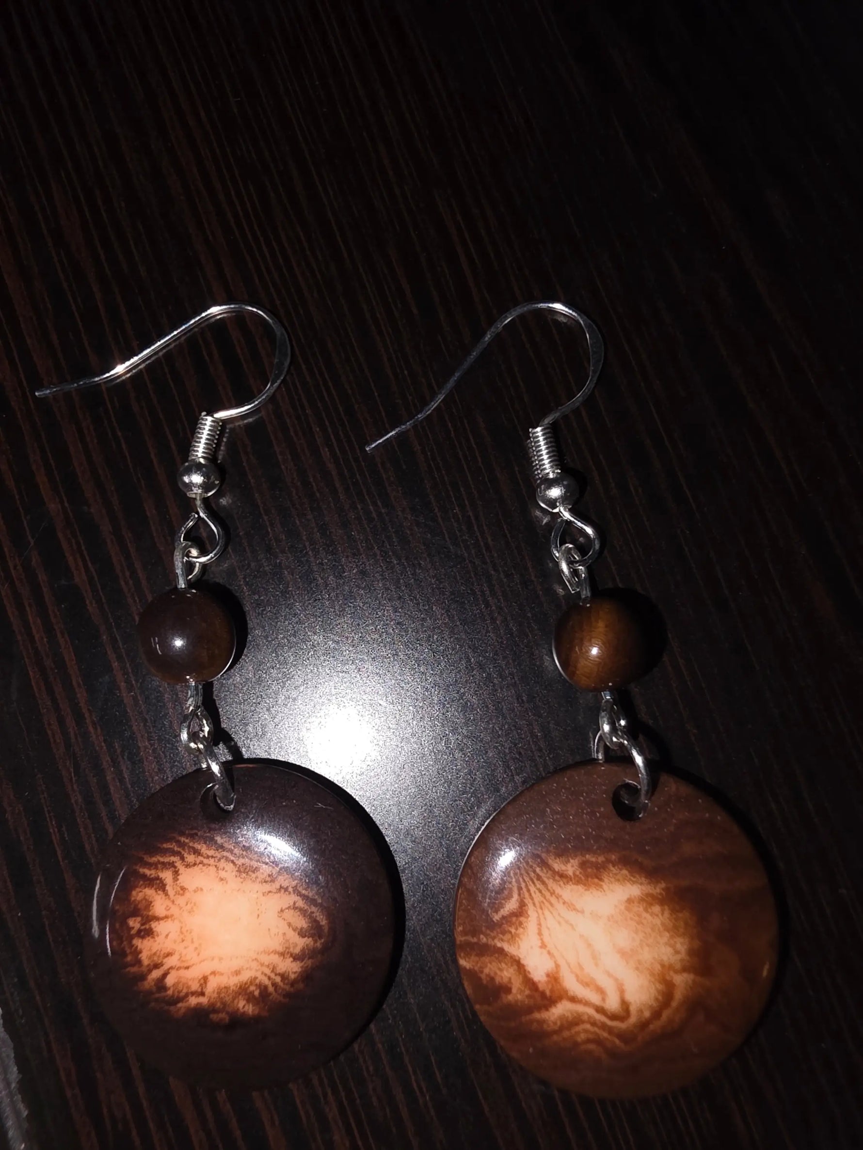 Brown circular misty chocolate tagua carved nut earrings with marbled pattern and small beads from ecuador rainforest