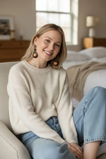 Cream-colored ribbed knit sweater paired with misty chocolate tagua carved nut earrings from the ecuador rainforest