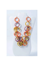 Vibrant chunky beaded tagua circles necklace with interlocking orange yellow and maroon rings from mona bold