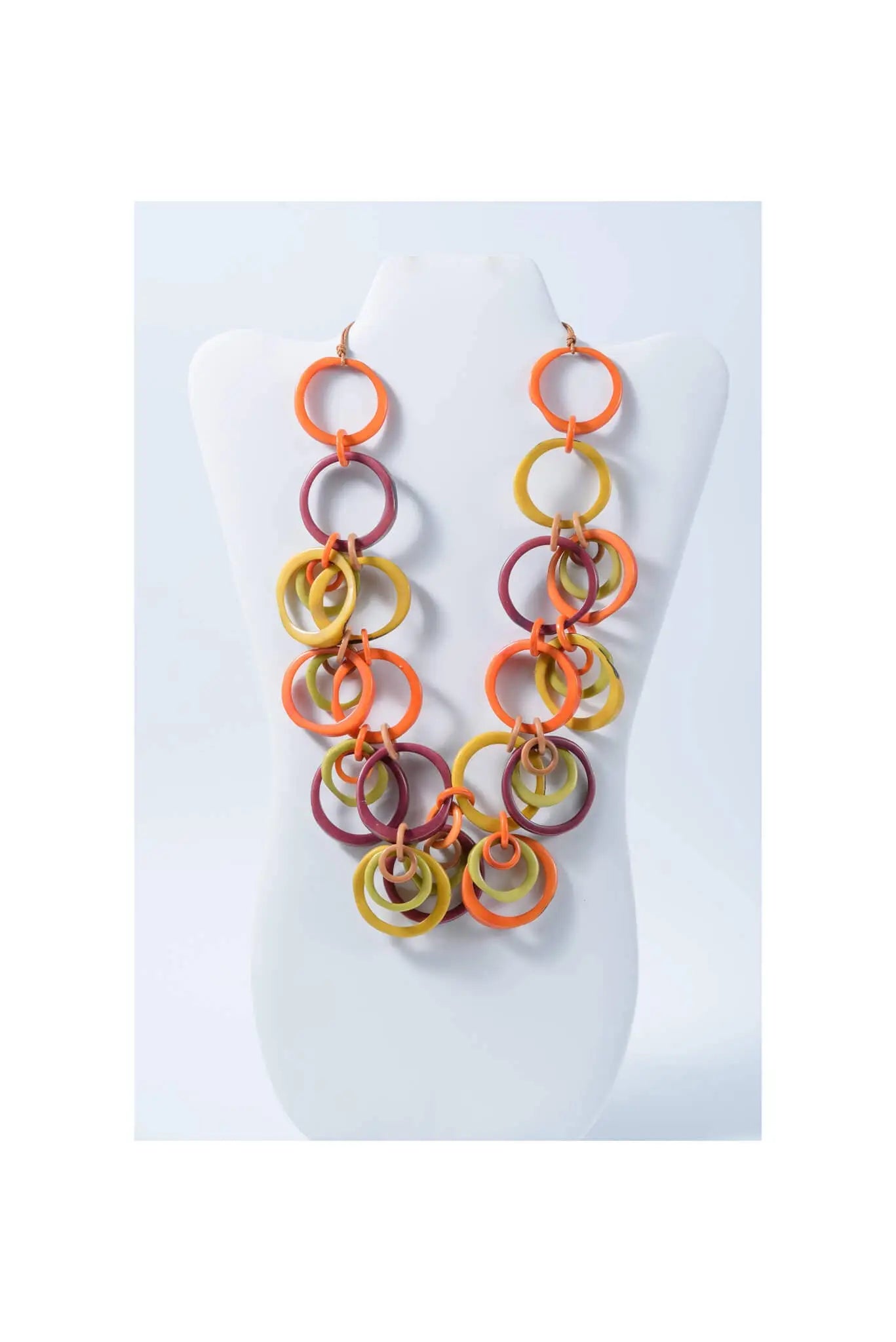 Vibrant chunky beaded tagua circles necklace with interlocking orange yellow and maroon rings from mona bold