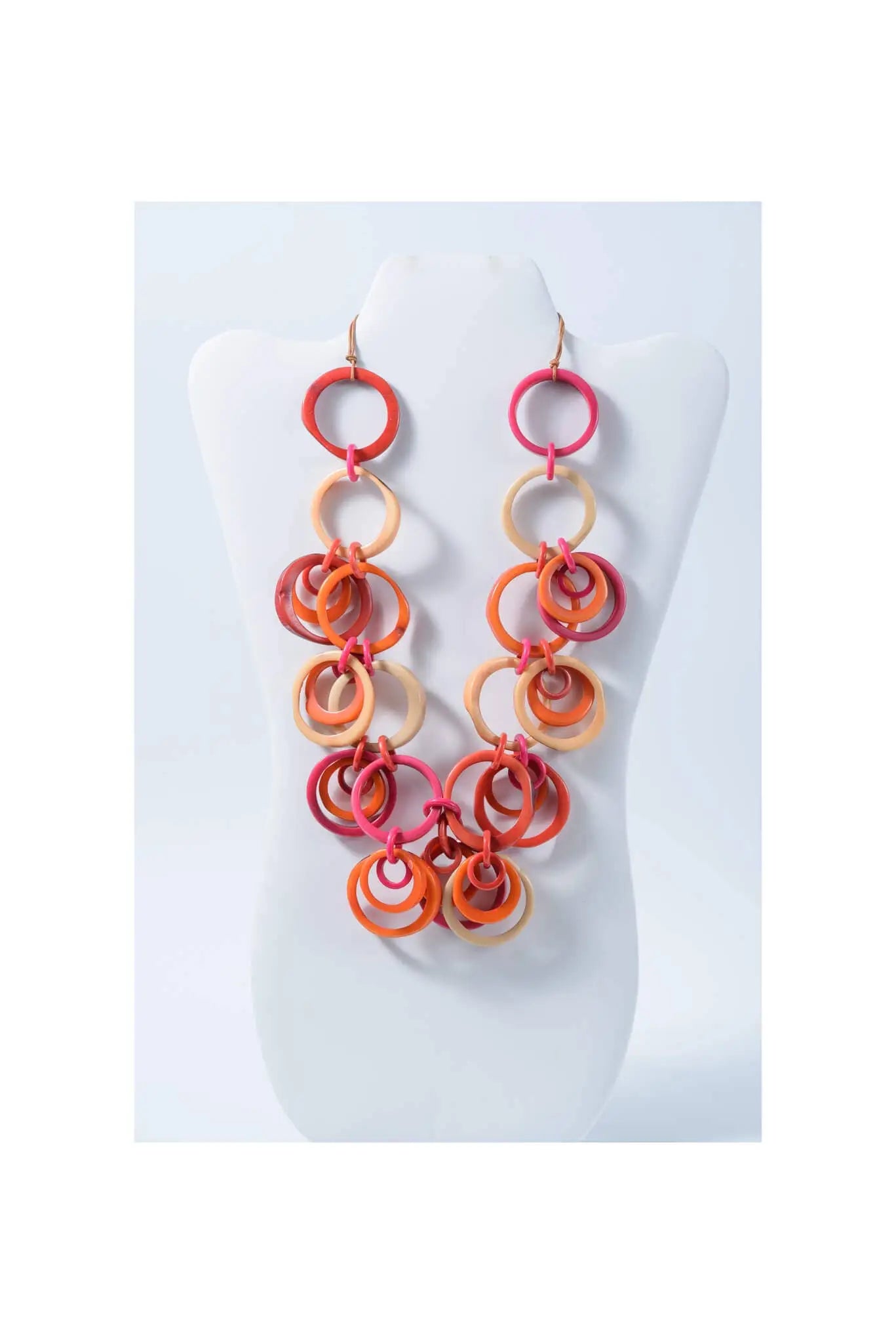 Vibrant multi-toned coral orange and pink chunky beaded tagua circles necklace with interlocking rings from Mona Bold