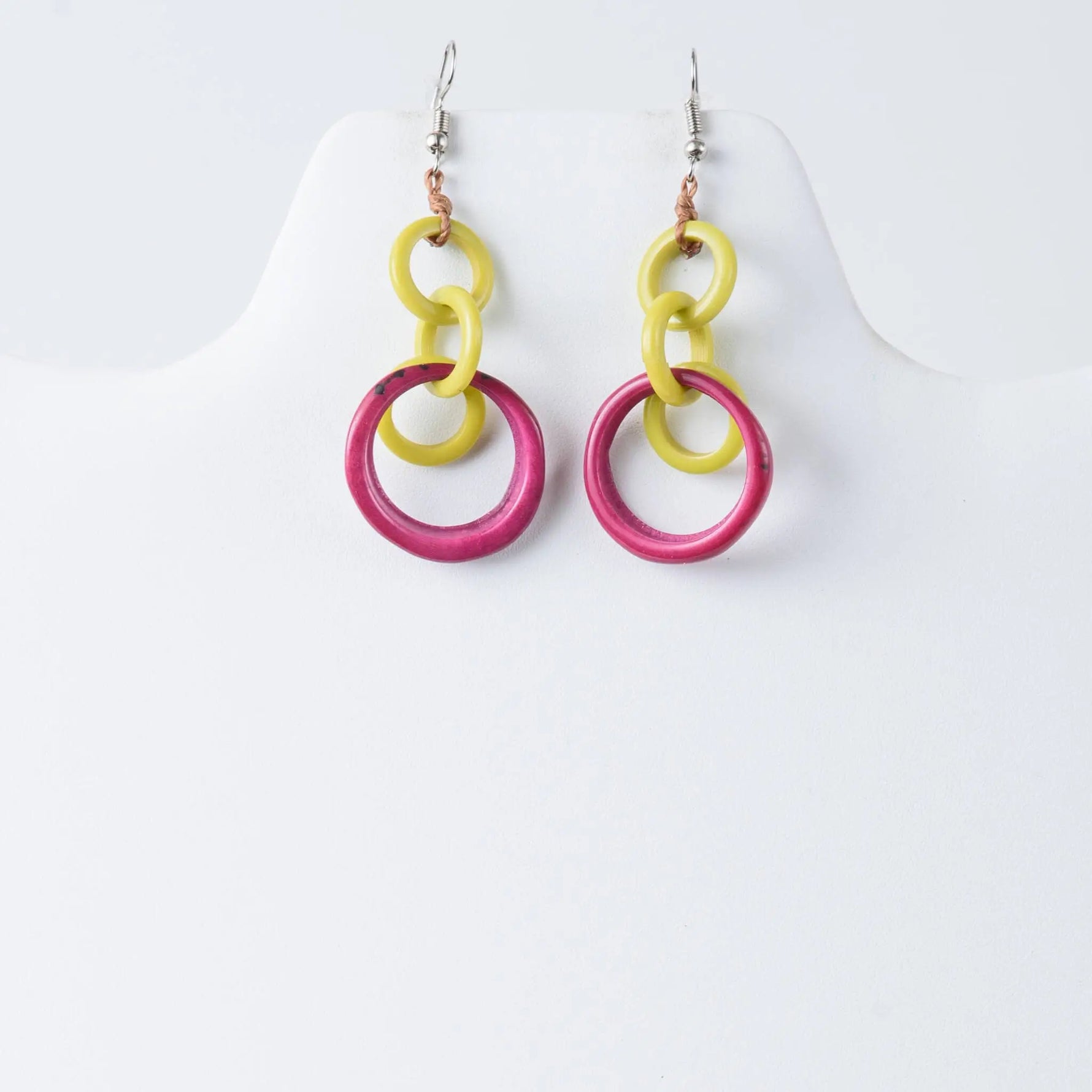 Bright yellow and fuchsia pink layered circle tagua earrings with a modern design for statement looks