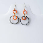 Orange cream and black circular resin tagua earrings with modern geometric design from mona drop and dangle collection
