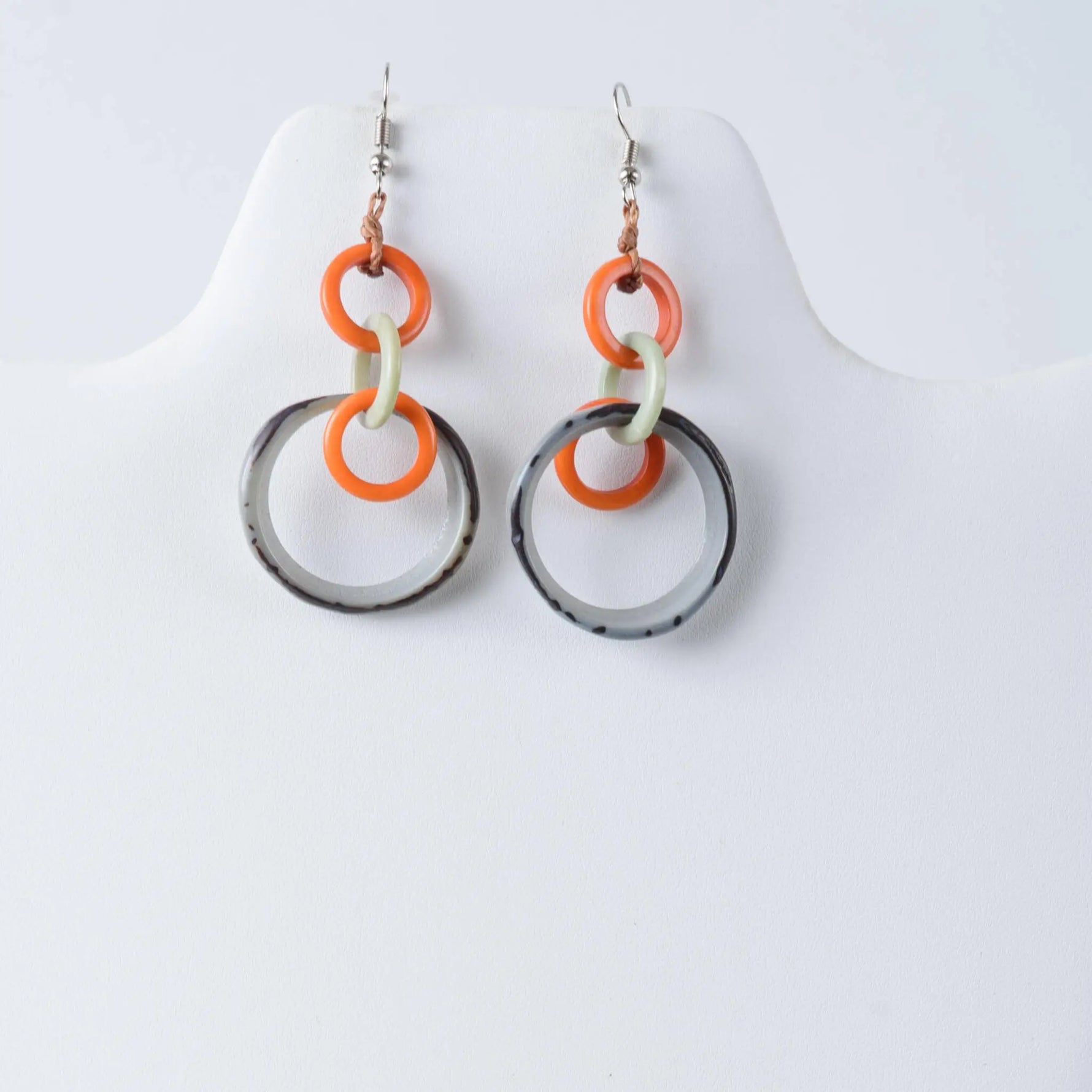 Orange cream and black circular resin tagua earrings with modern geometric design from mona drop and dangle collection