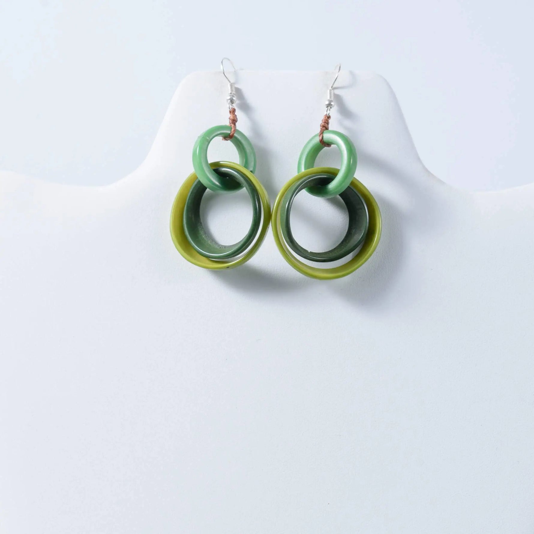 Green layered circular mona drop and dangle tagua earrings with glossy finish and silver hooks
