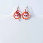 Vibrant orange and pink double-ring glossy tagua earrings perfect as statement drop and dangle circles
