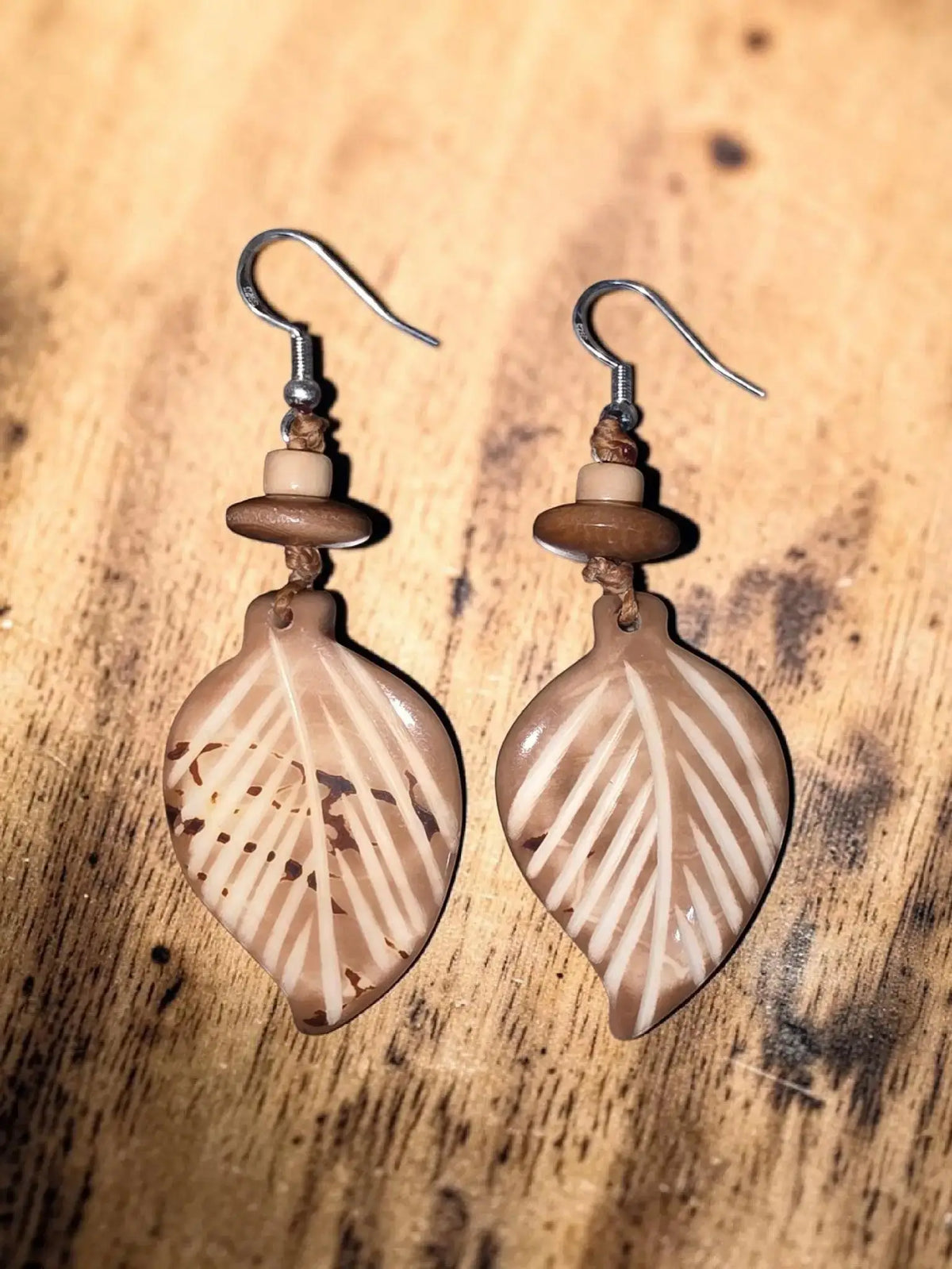 Natural earth tan leaf earrings carved from tagua with white veining and wooden bead for elegance natural warmth