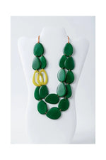 Naty dual-strand sculptural tagua necklace with bold green teardrop beads and a central yellow circular accent
