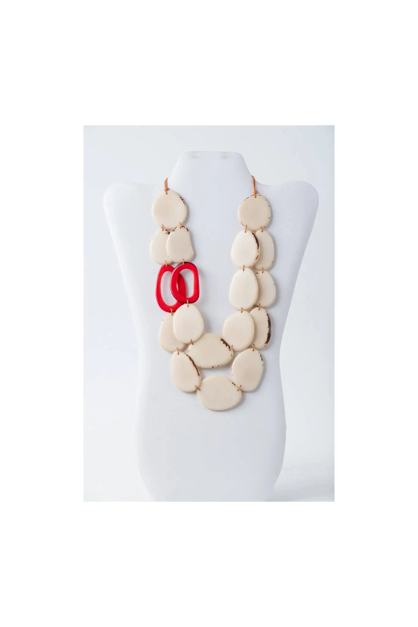 Cream-colored oval resin beads necklace with glossy finish and bold red circular links in naty dual-strand tagua necklace