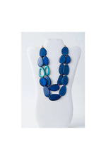 Naty dual-strand sculptural tagua necklace with layered oval beads in blue shades and translucent turquoise accents