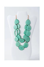 A turquoise dual-strand tagua necklace with matte finish and irregular teardrop ceramic beads by naty