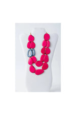 Vibrant fuchsia and gray dual-strand sculptural tagua necklace with teardrop-shaped beads perfect for statement style