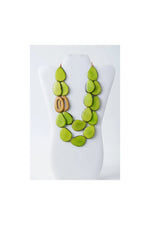 Vibrant lime green teardrop tagua beads with wooden o-ring accent make up the bold naty dual-strand sculptural necklace
