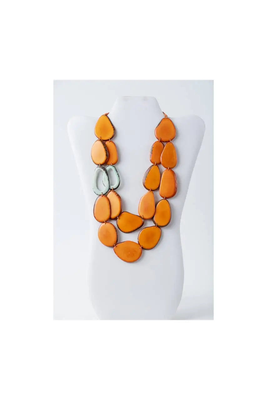 Naty dual-strand sculptural tagua necklace with vibrant orange teardrop beads and silver-toned circular accents