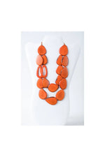 Naty dual-strand sculptural tagua necklace with vibrant orange teardrop beads for a bold statement look