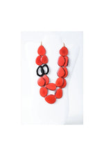 Naty dual-strand sculptural tagua necklace with vibrant red teardrop beads and black circular accents layered design