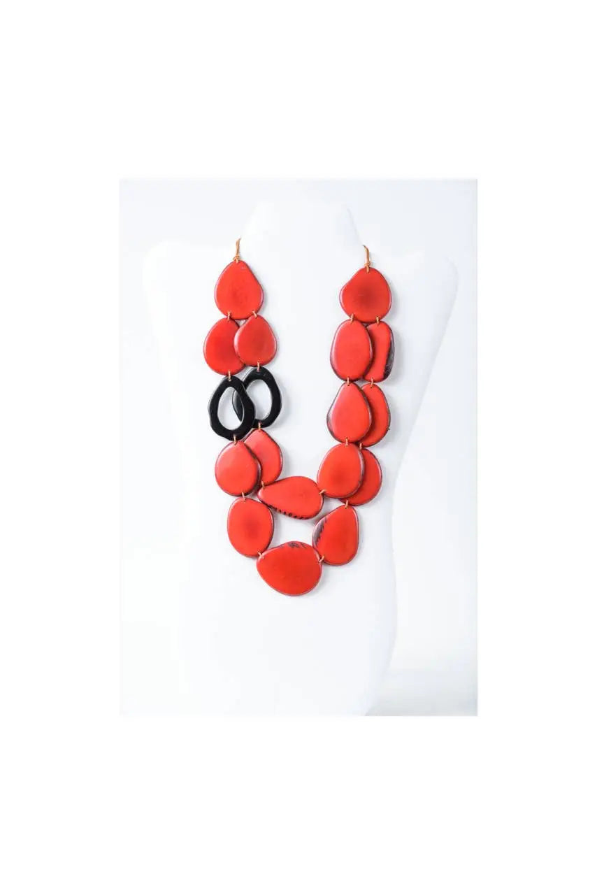 Naty dual-strand sculptural tagua necklace with vibrant red teardrop beads and black circular accents layered design
