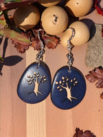 Deep blue teardrop tagua slice earrings with a silver tree laser cutout design