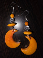 Orange marmalade crescent moon carved tagua nut earrings with silver sunflower floral beads and hooks