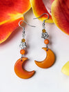 Orange moon carved tagua nut earrings with silver floral charms and amber beads featuring orange cut glass